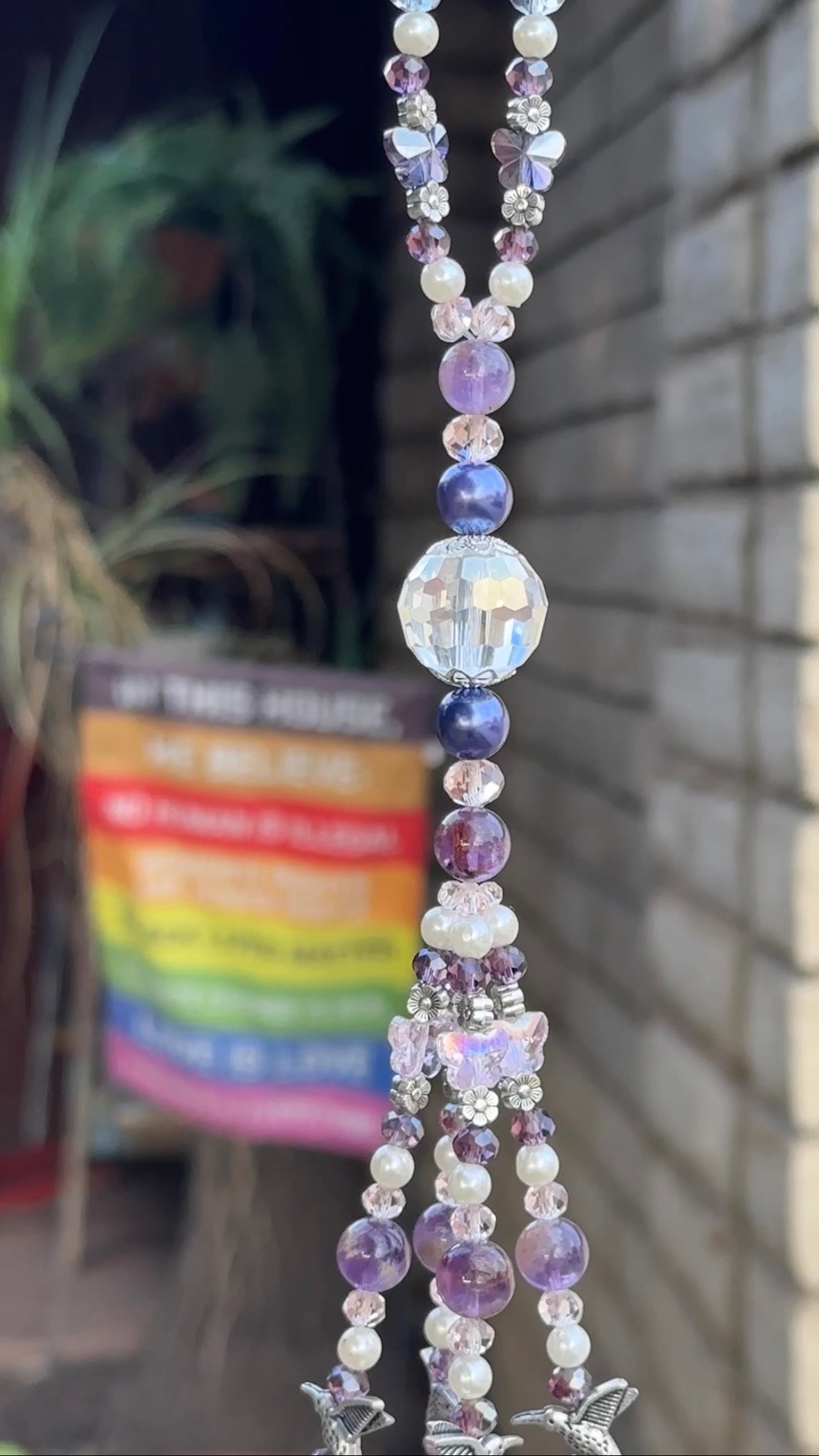 Decorative purple and crystal jeweled top loop with a blurred background